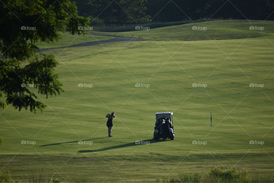 Lone lady golfer in the early evening