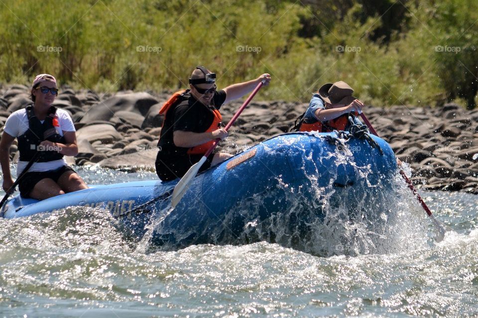 Group of friends enjoying rafting