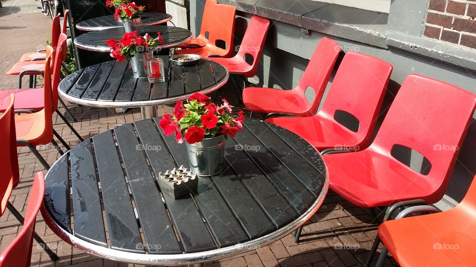 Red chairs at outdoor cafe in Amsterdam