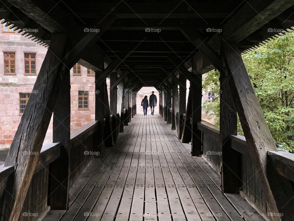 Tiny people walking by the bridge 