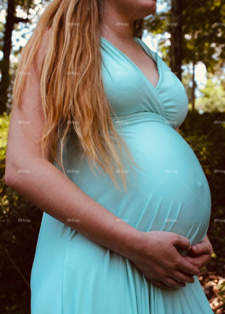 Side view of baby bump with hair swept to the side 