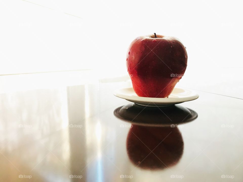 A red apple on a plate