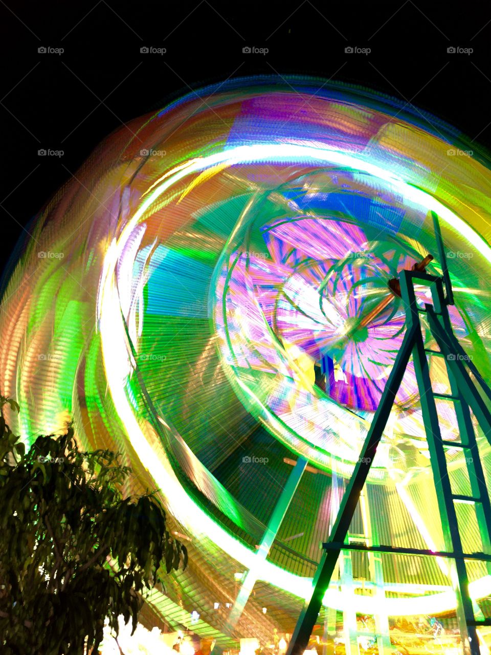 abstract of ferris wheel at night in motion shot at long exposure