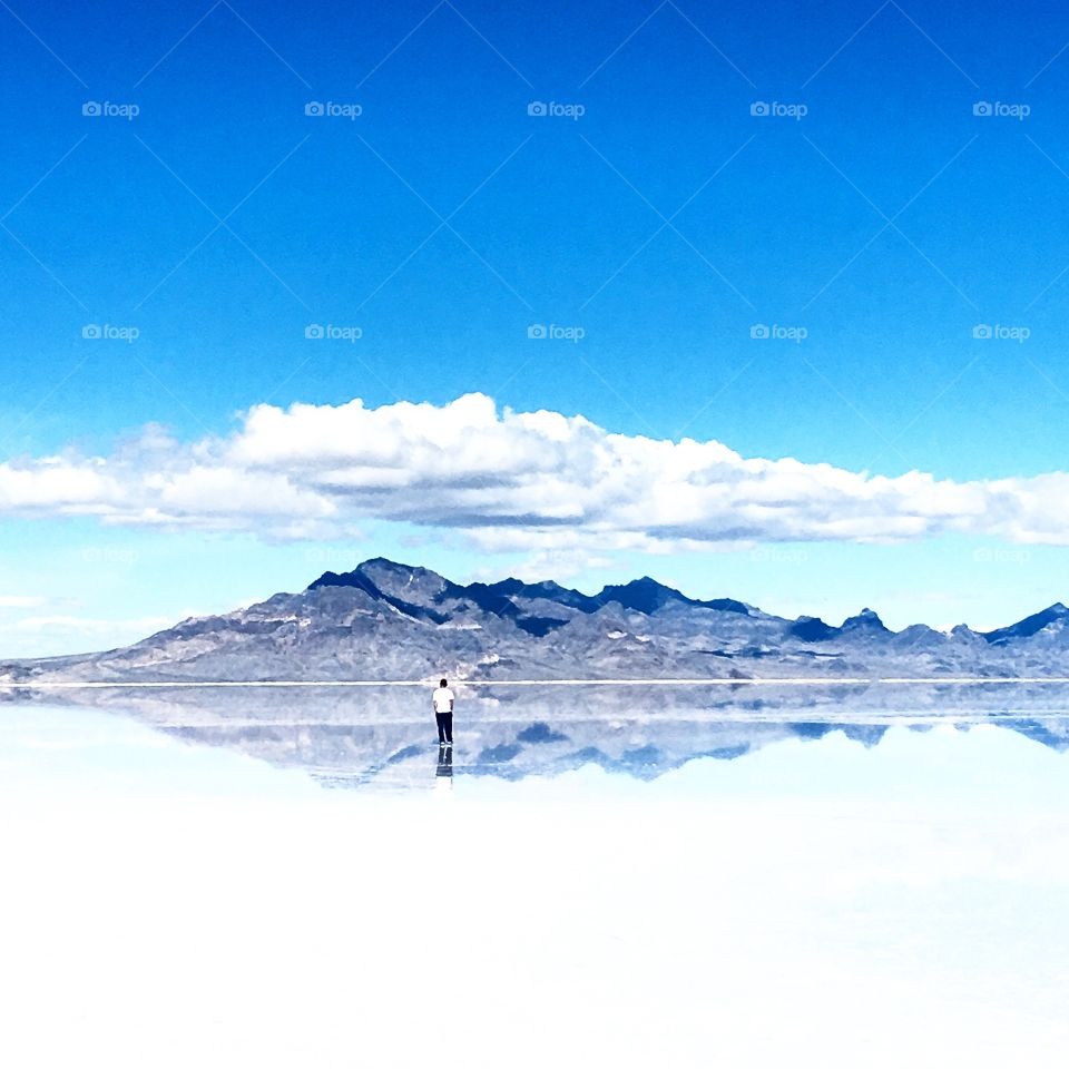 Distant view of a person standing on salt flats