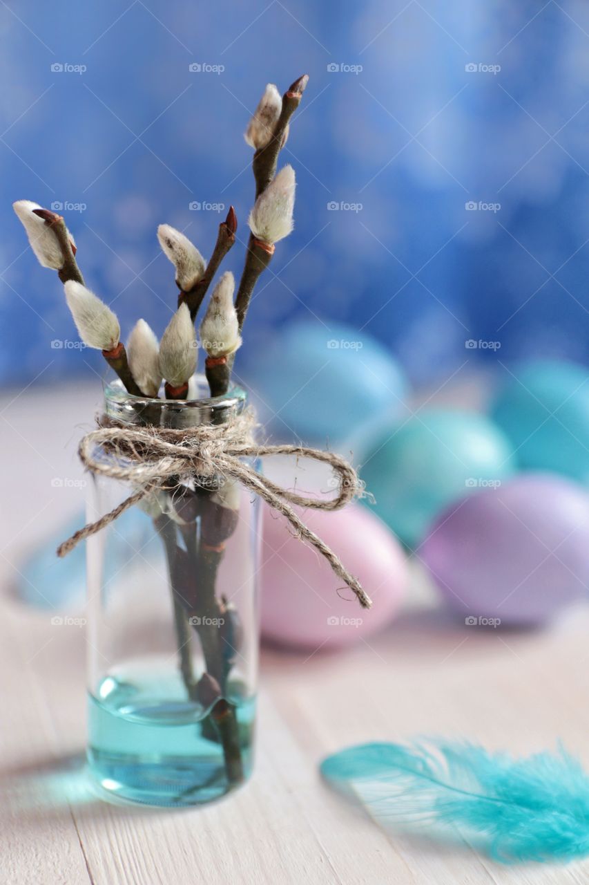 Easter eggs and willow branches in a vase