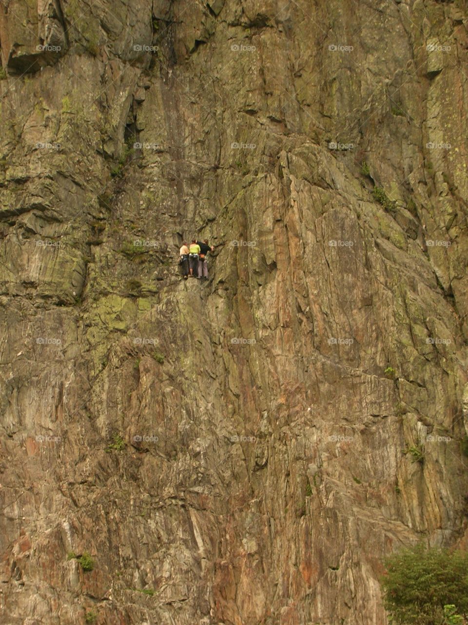 Three climbers on a cliff