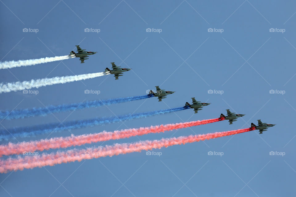 Military aircraft with colored smoke. A group of military aircraft. Aircraft interceptor. 
