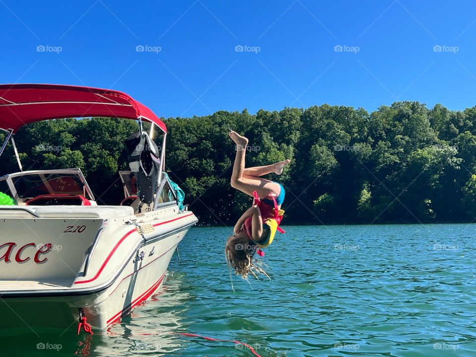 Summer fun jumping of the boat and making childhood memories 