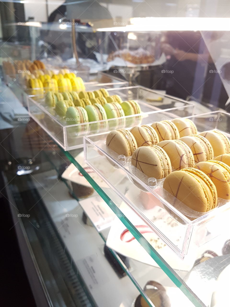 Lineup of macaroons in a glass counter