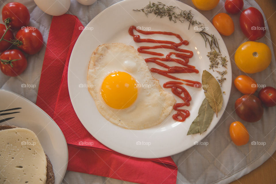 Eggs, tomatoes, bread and cheese in a beautiful bright flat lay