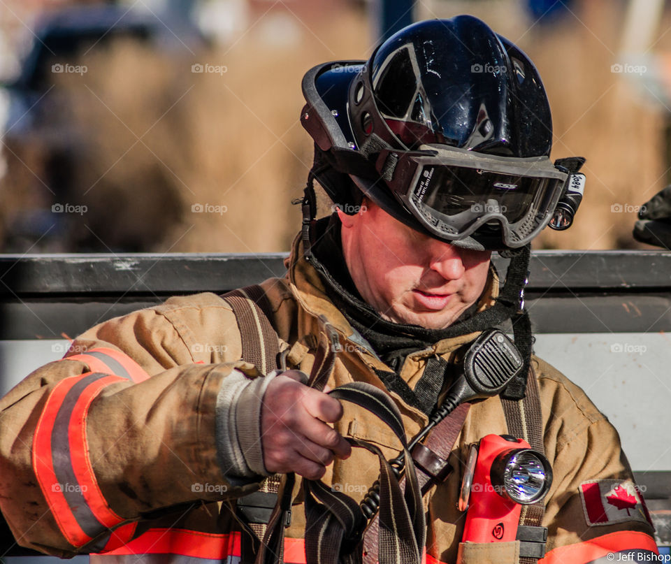 Fireman holding fire hose in uniform
