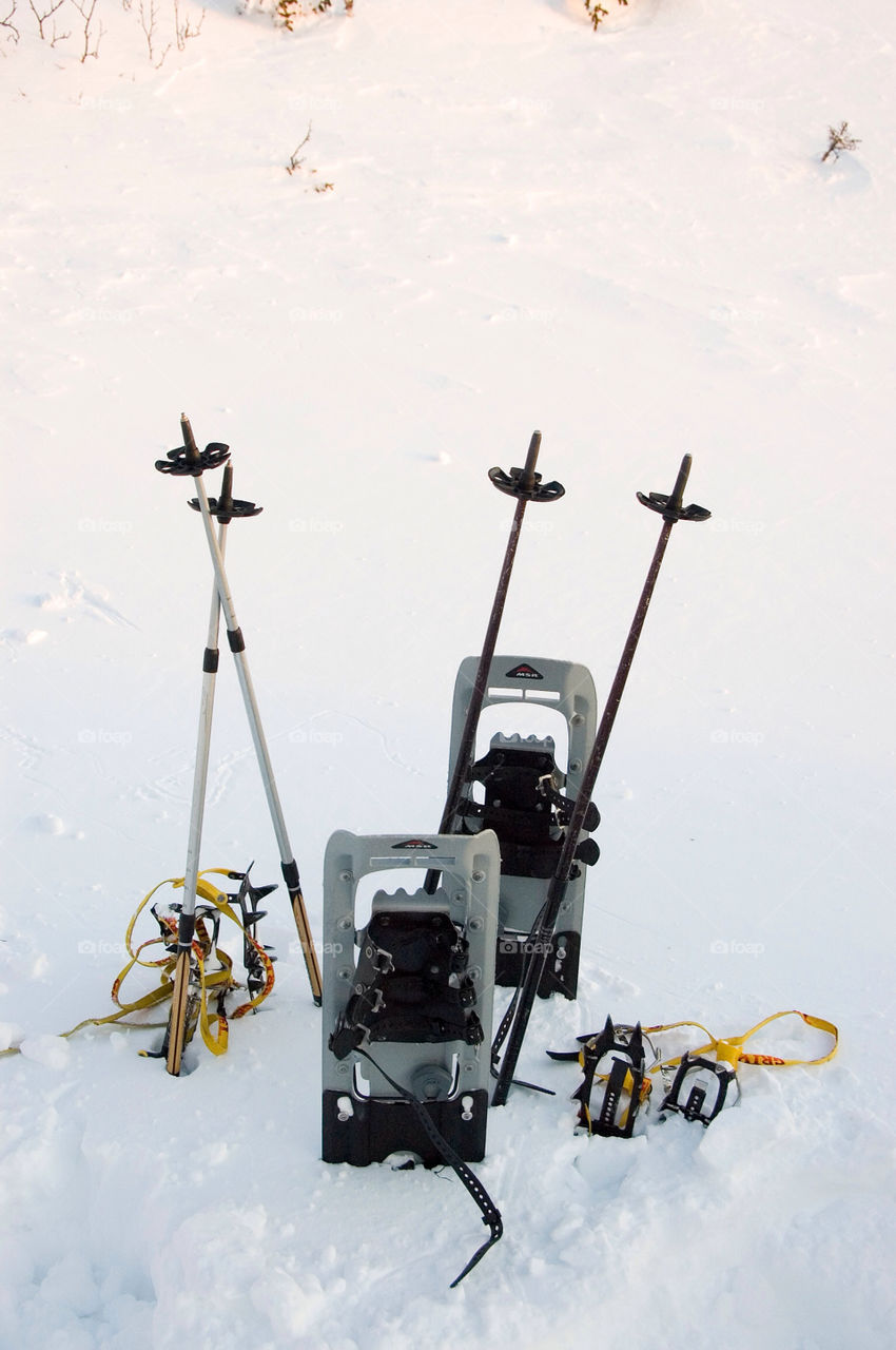 Snowshoes polls and crampons after a long hike on the mountains