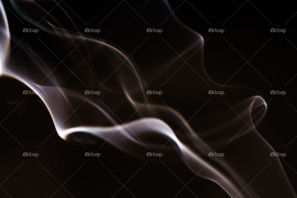 Smoke scented candles on a black background