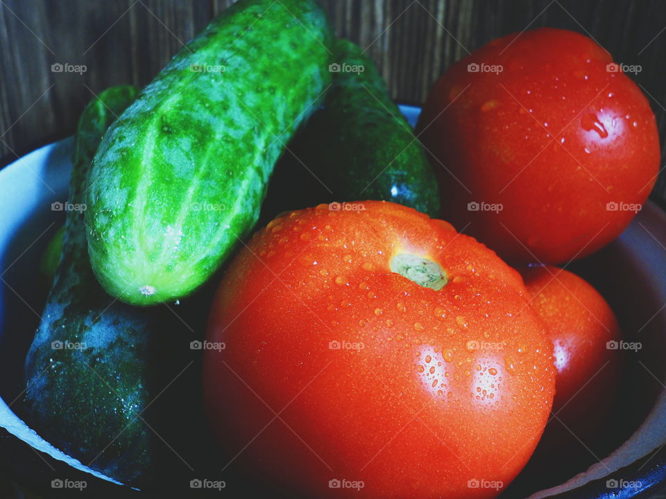 vegetables red tomatoes and cucumbers in a bowl