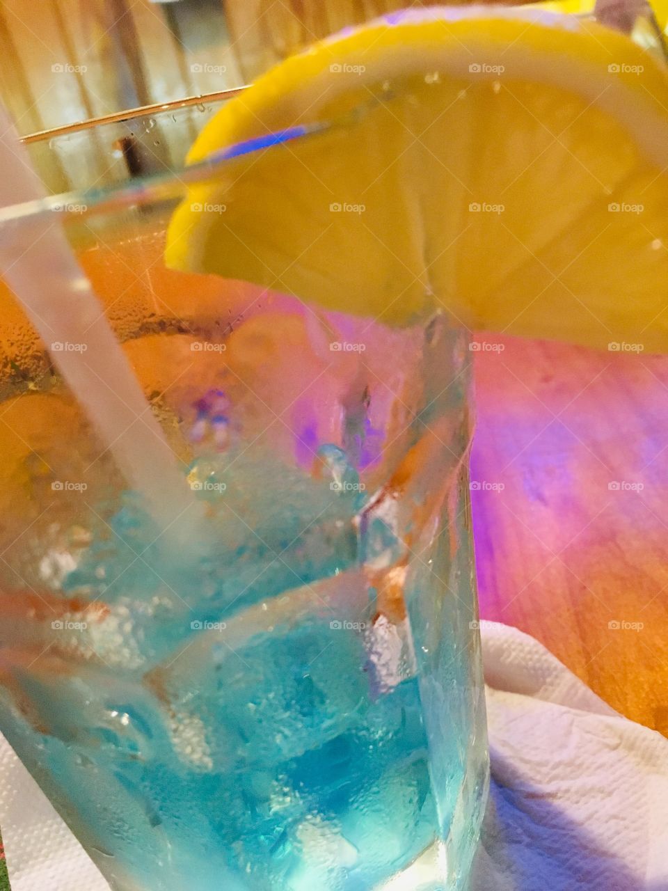 Half drank blue Long Island ice tea with a lemon wedge at Gator’s Dockside in Florida 