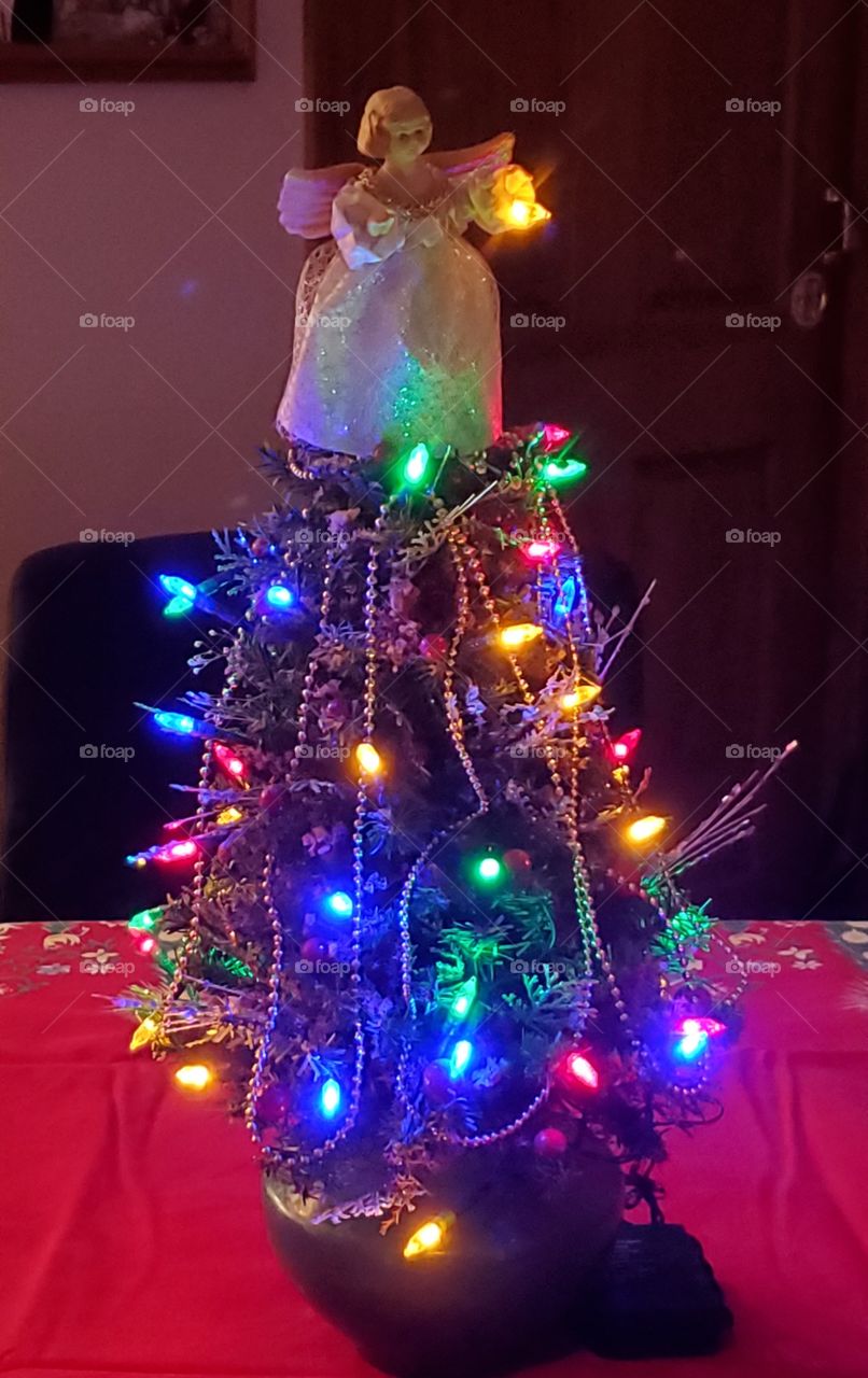 Hand made Christmas Tree for table top with battery lights & topped with an Angel. Battery multicolor Christmas lights are on a timer too!