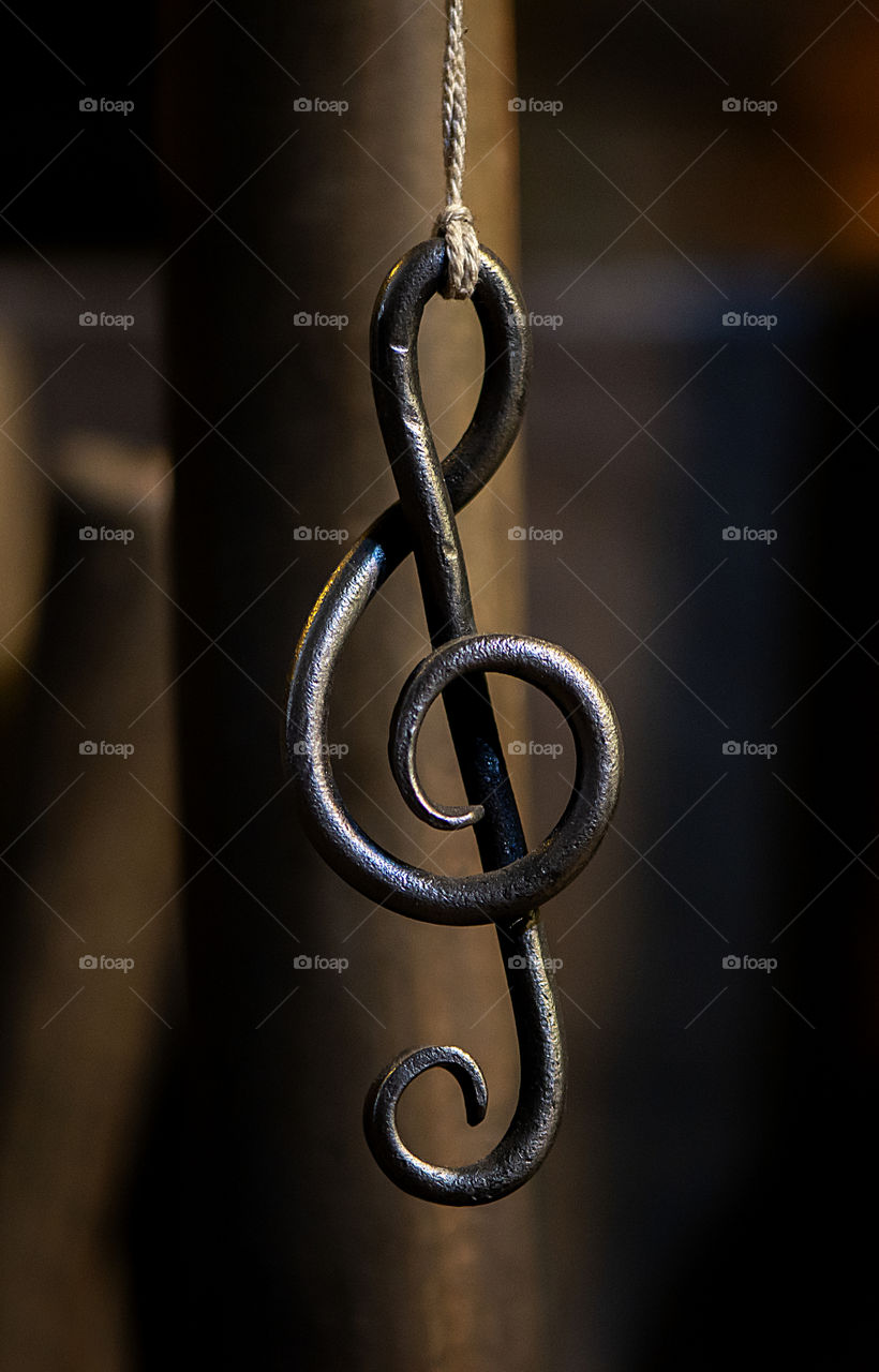 metal sheet music key hangs in a rope bla cksmith workshop