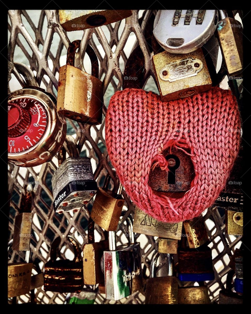 Love locks on a bridge, lock with knitting on it, love locks, couple places locks on bridge, locks for LGBTQ love 