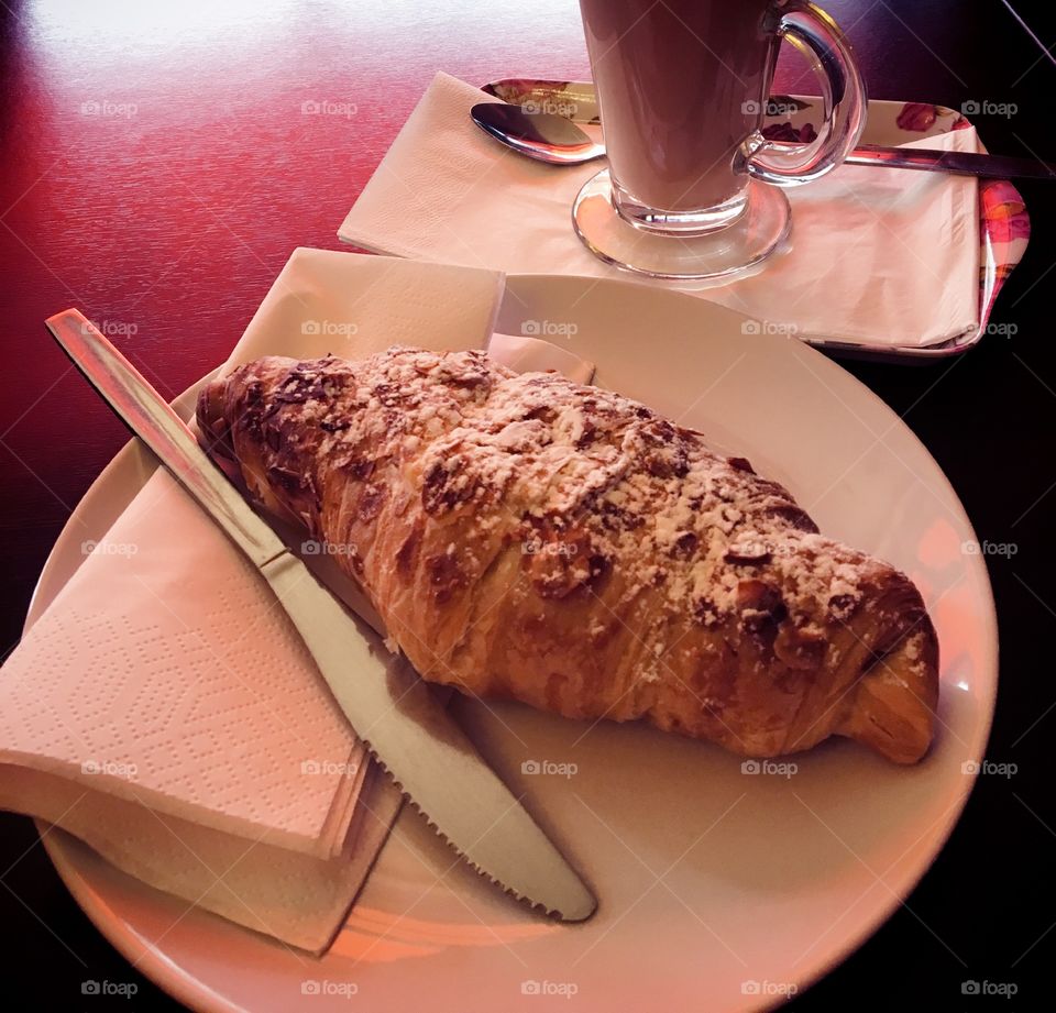 Almond croissant for breakfast with cafe latte.