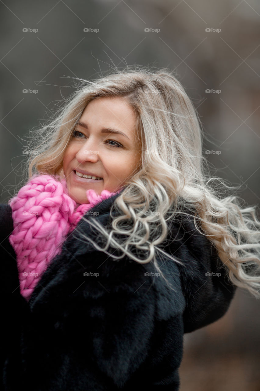 Outdoor Portrait of blonde woman in pink crochet accessories 