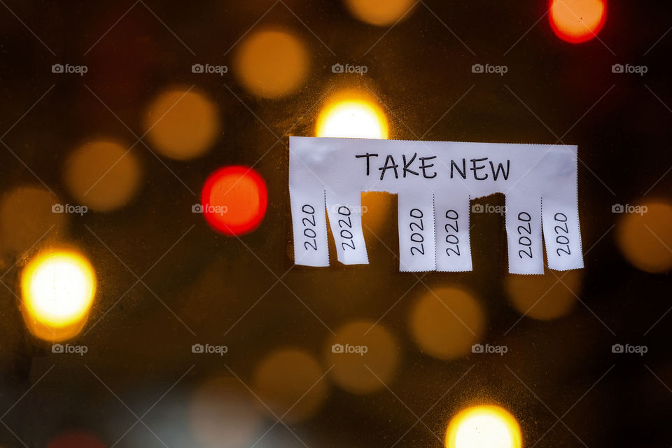 Christmas shop window with paper with the phrase: Take New and with a 2020 sign ready to be tore off