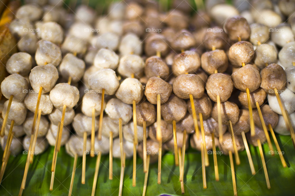 Grilled meat balls skewers at the local market. Thai street food