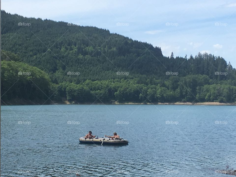 Grandfather and grandson on the lake