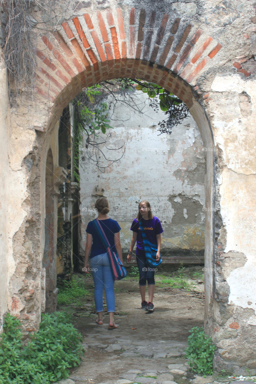 Two tourists exploring a ruined place