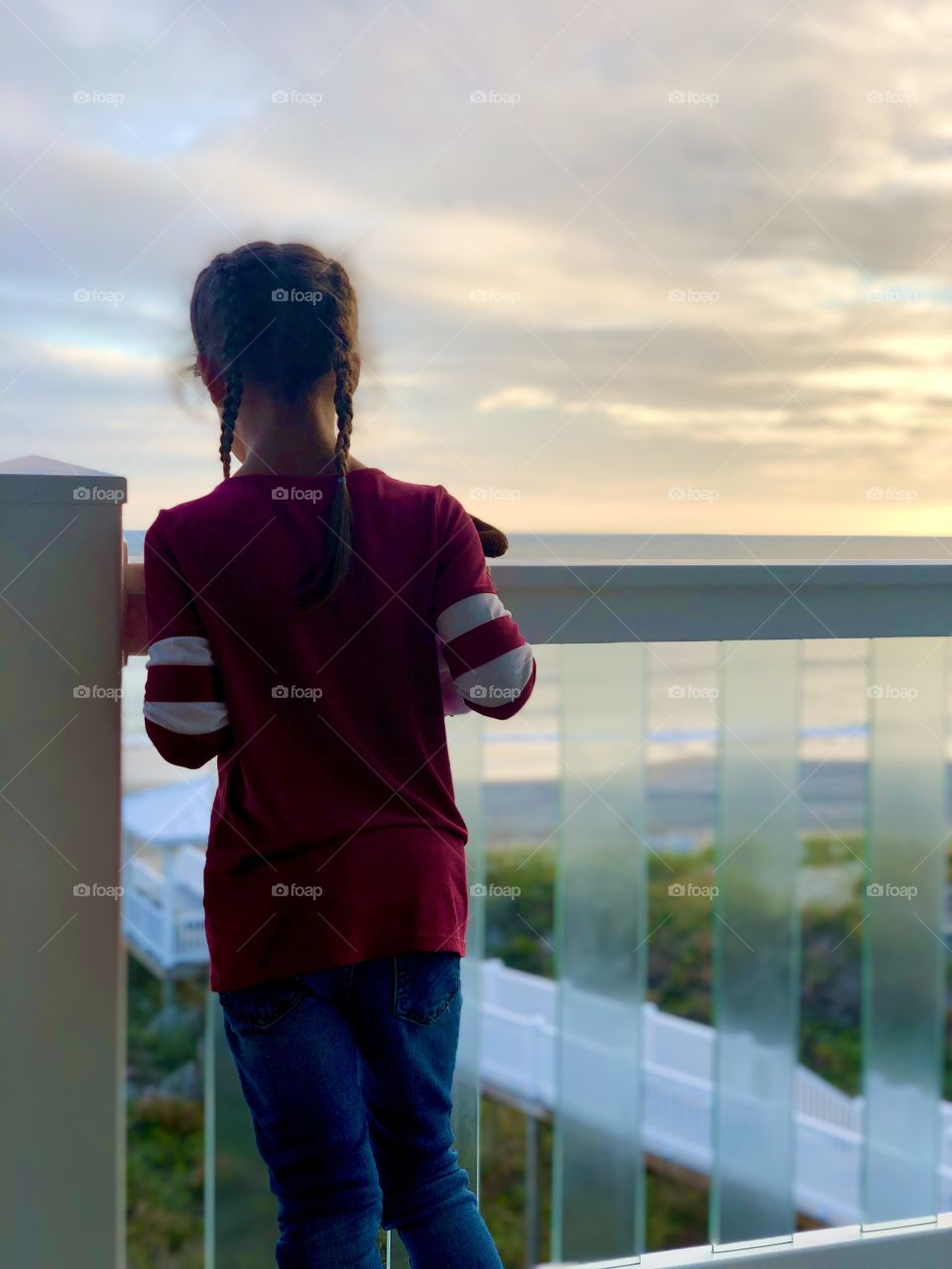 Child looking into the ocean shore from an oceanfront view