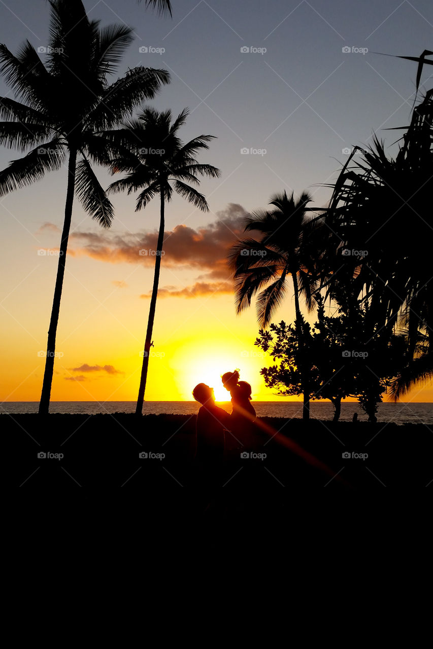 Father and daughter at sun set