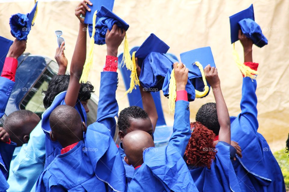 gowngown happy, healthy  Nigerian elementary school kids graduating