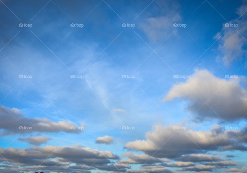 Bright blue sky with white fluffy clouds