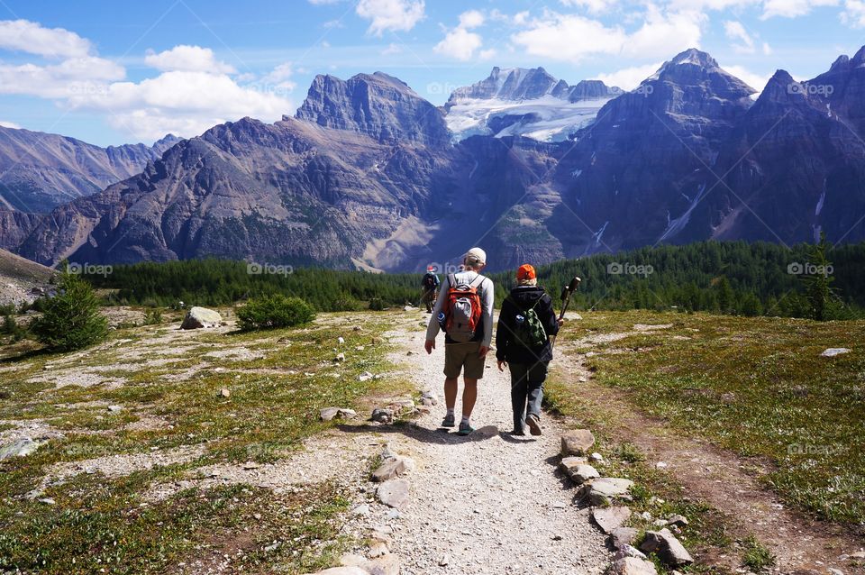 Rear view of people walking in mountain