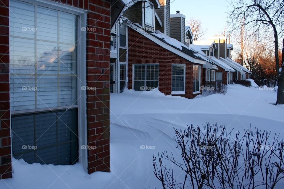 Snow drifts covering homes