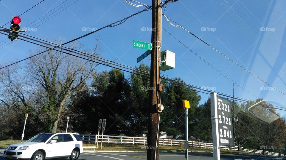 Stop light, street sign, gas station sign