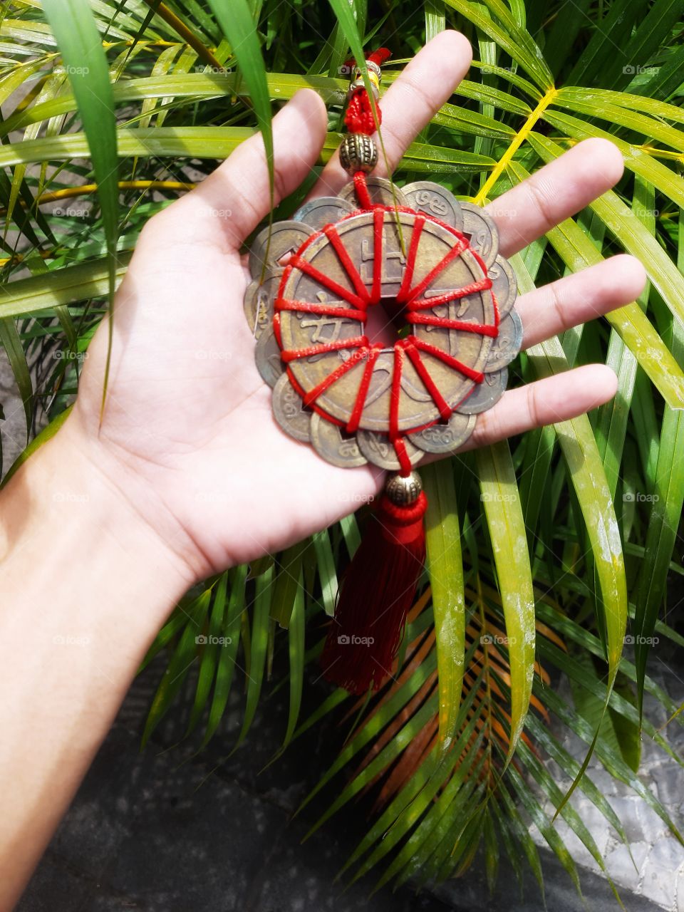 A chinese unique dreamcatcher is in left hand.