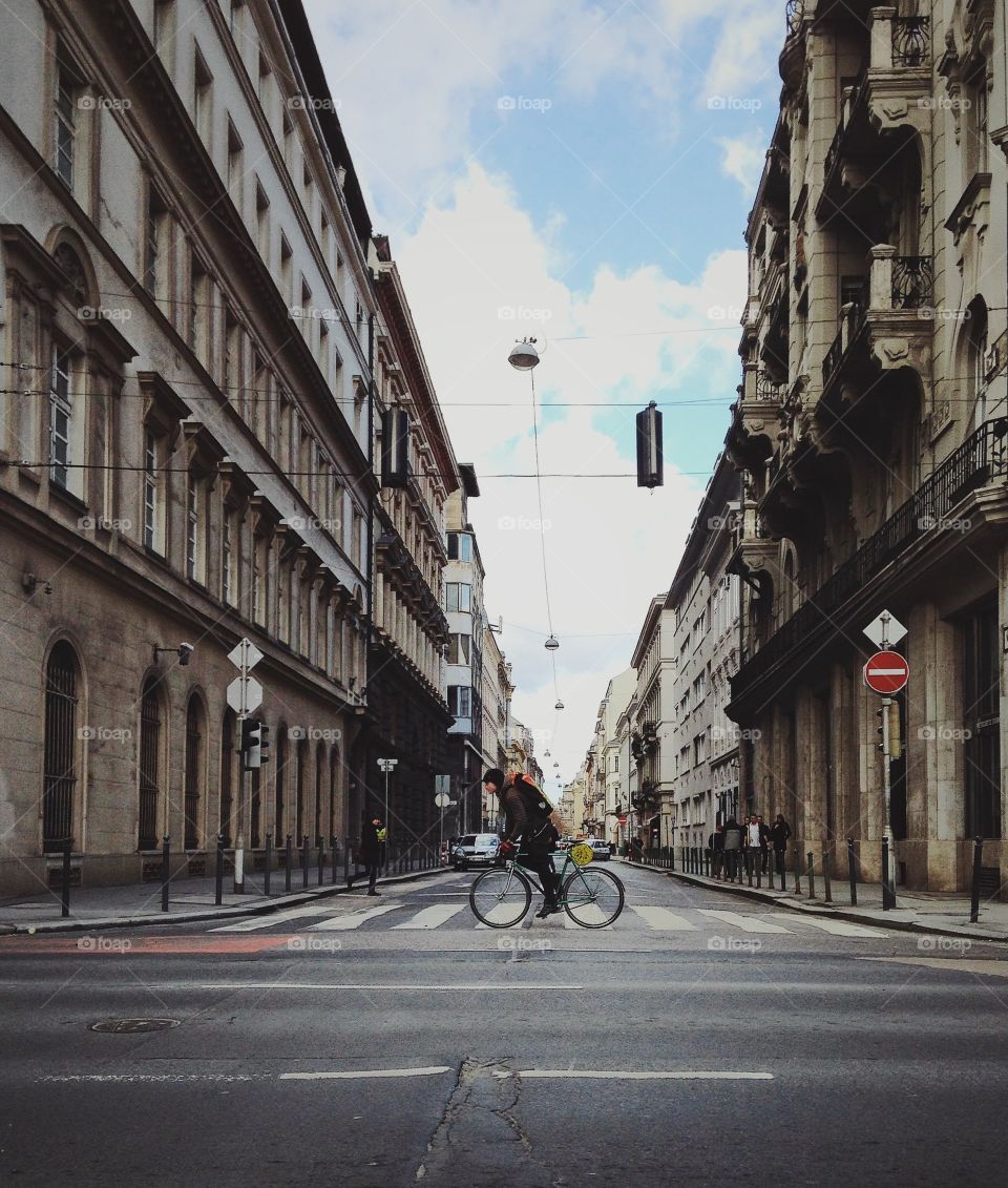 Man passing the street by bicycle 