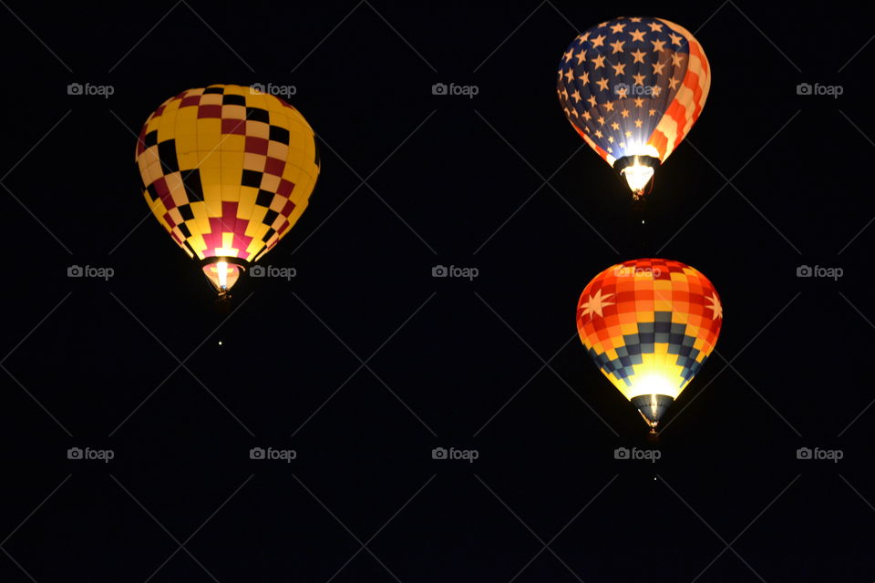 Illuminated hot air balloon in sky at night