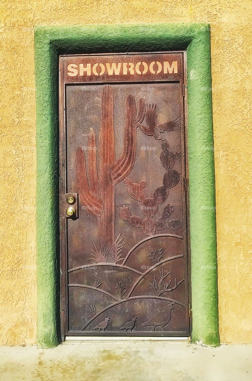 Beautiful Metal Door Doorframe Entryway Passage Exit Entrance Into Showroom foe Business with Saguaro Cactus Southwestern Theme.