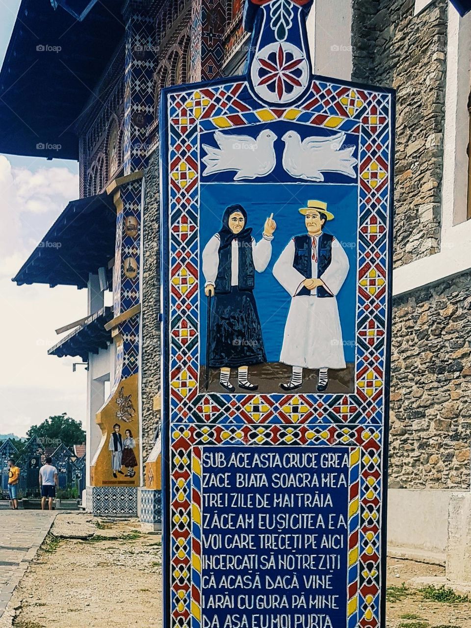 wooden cross painted with funny poetry