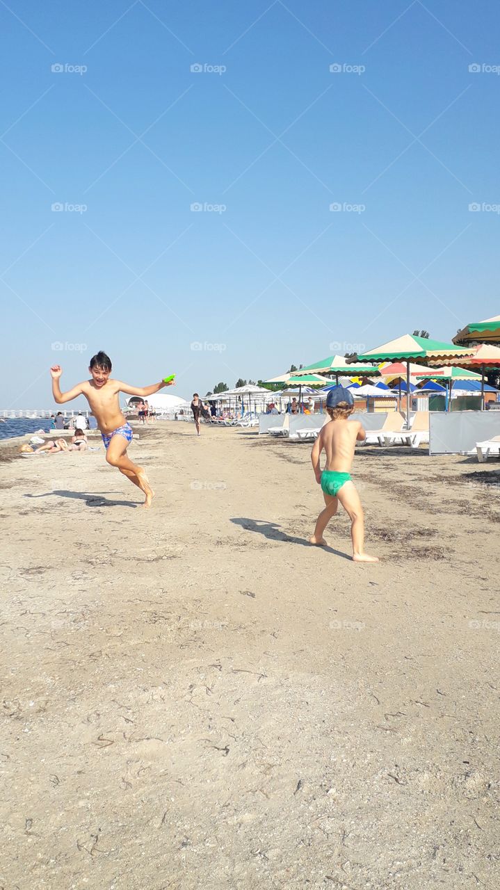 two boys playing on the beach