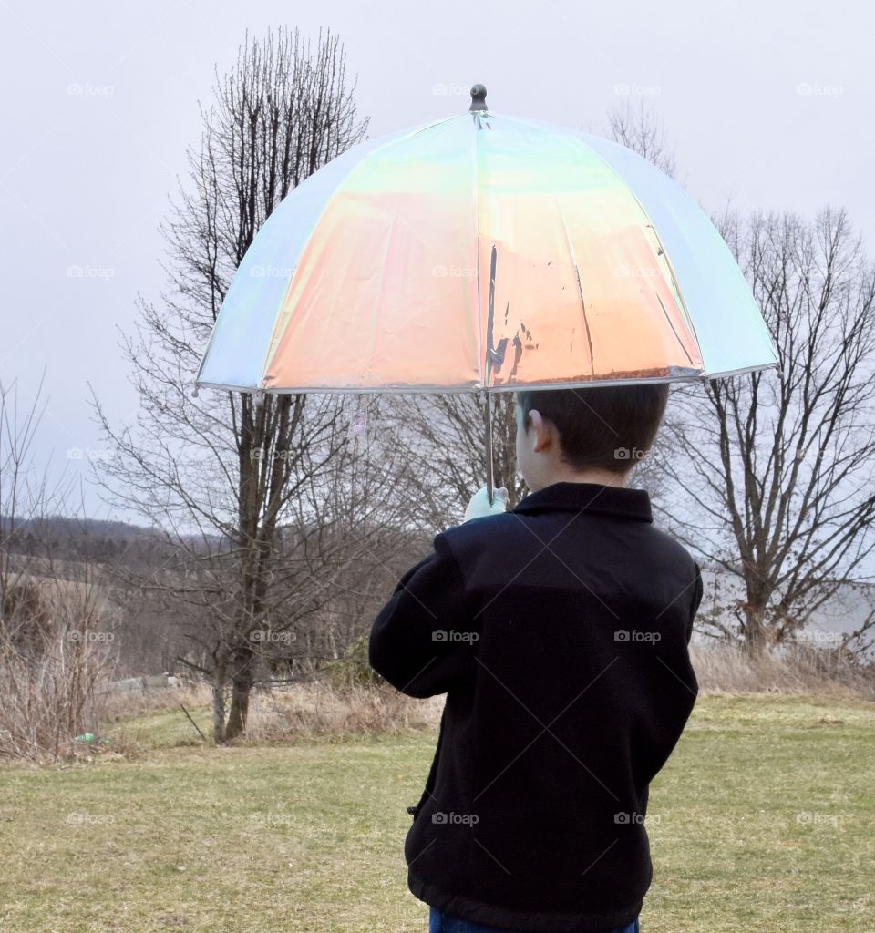Young boy holding a Totes umbrella 