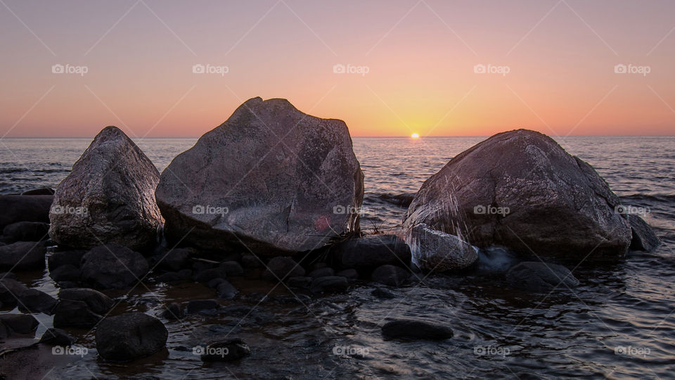 three brothers rock on the beach at sunset hour