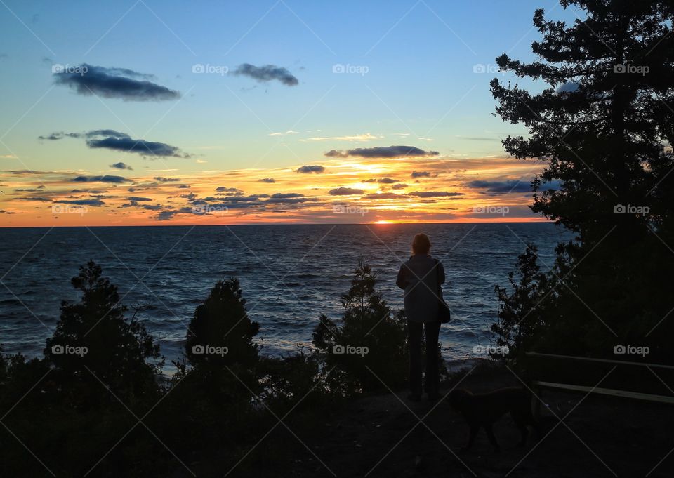 Silhouette of a woman looking at sunset