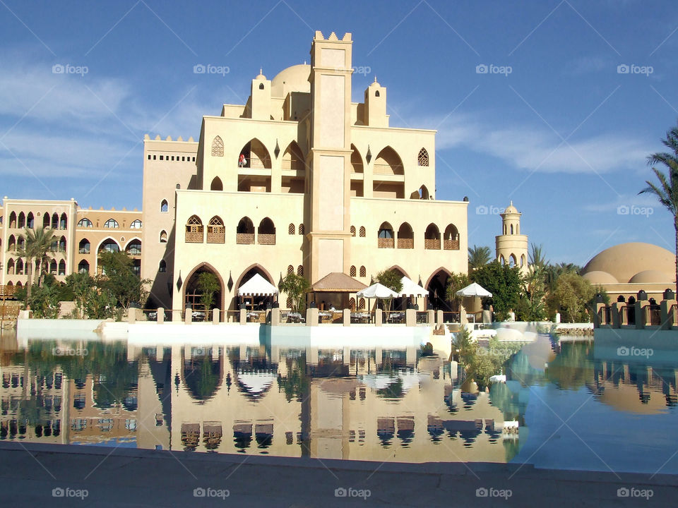 Hurghada Egypt- building mirroring in pool in daytime captured picture; red Sea resort