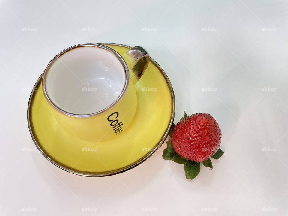 Strawberry and yellow cup and saucer 