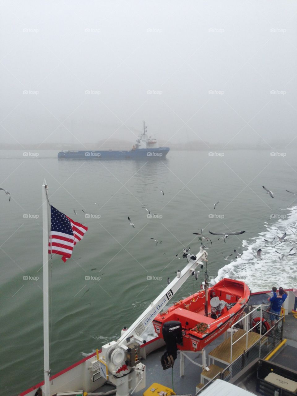 Boat in the fog with the American flag 