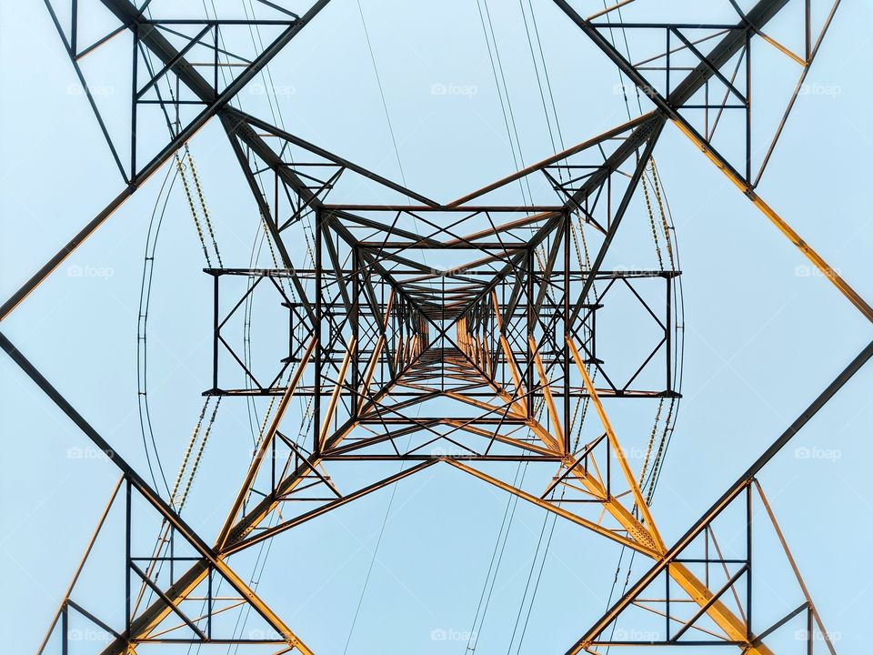 Looking up at the beautifully symmetric electricity pylons