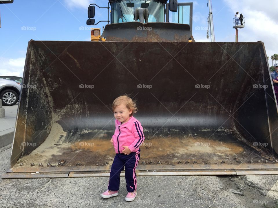 Child in front of dozer. Child and I went to long beach and they had hundreds of vehicles and trucks on display