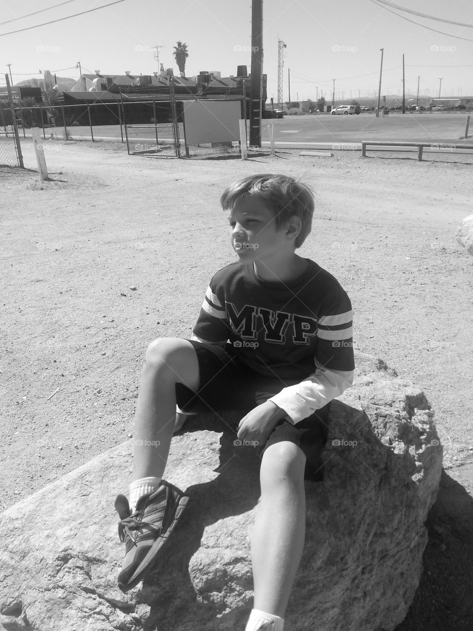 my son sittin on a rock. we spent the day in the Mojave desert